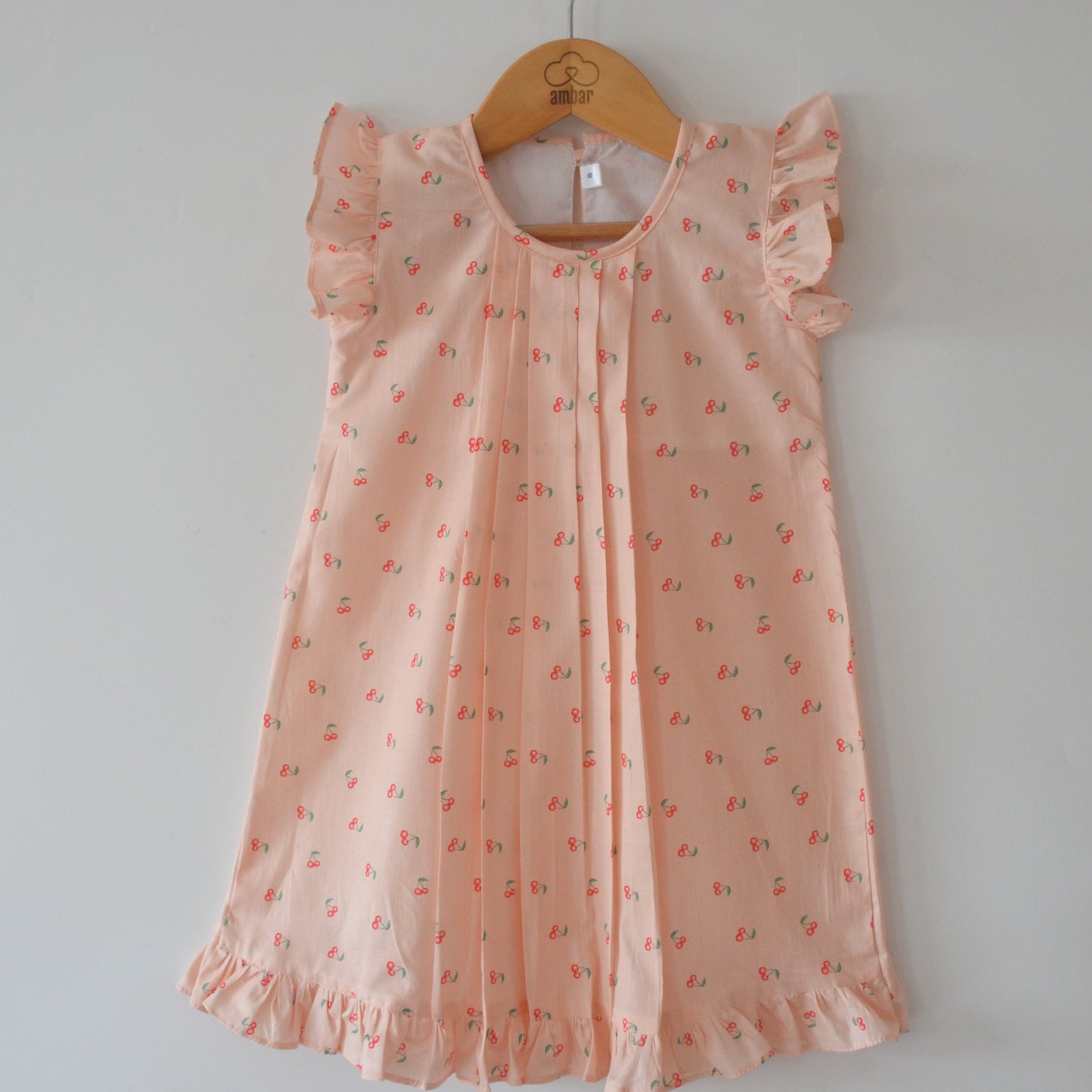 Matilda dress in cherry print with front pleats - Peach
